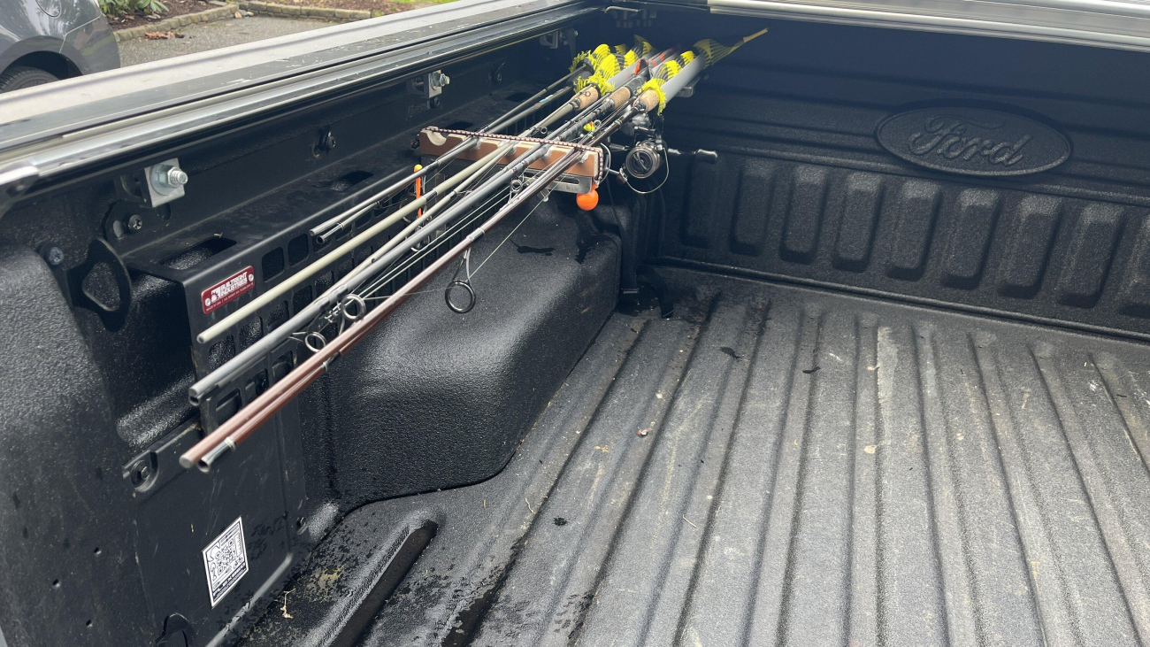 Saltwater fishing rods stored in the truck's cargo bed.