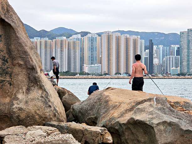 People are fishing on the rocks.